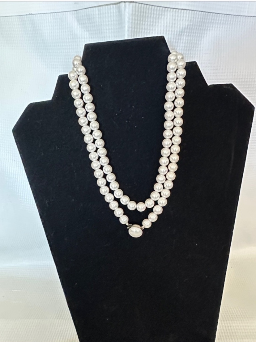 Classic Double-Strand White Pearl Necklace with Oval Clasp.